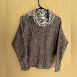 Cozy sweater with a beautiful loose turtleneck shimmering with silver sequins.